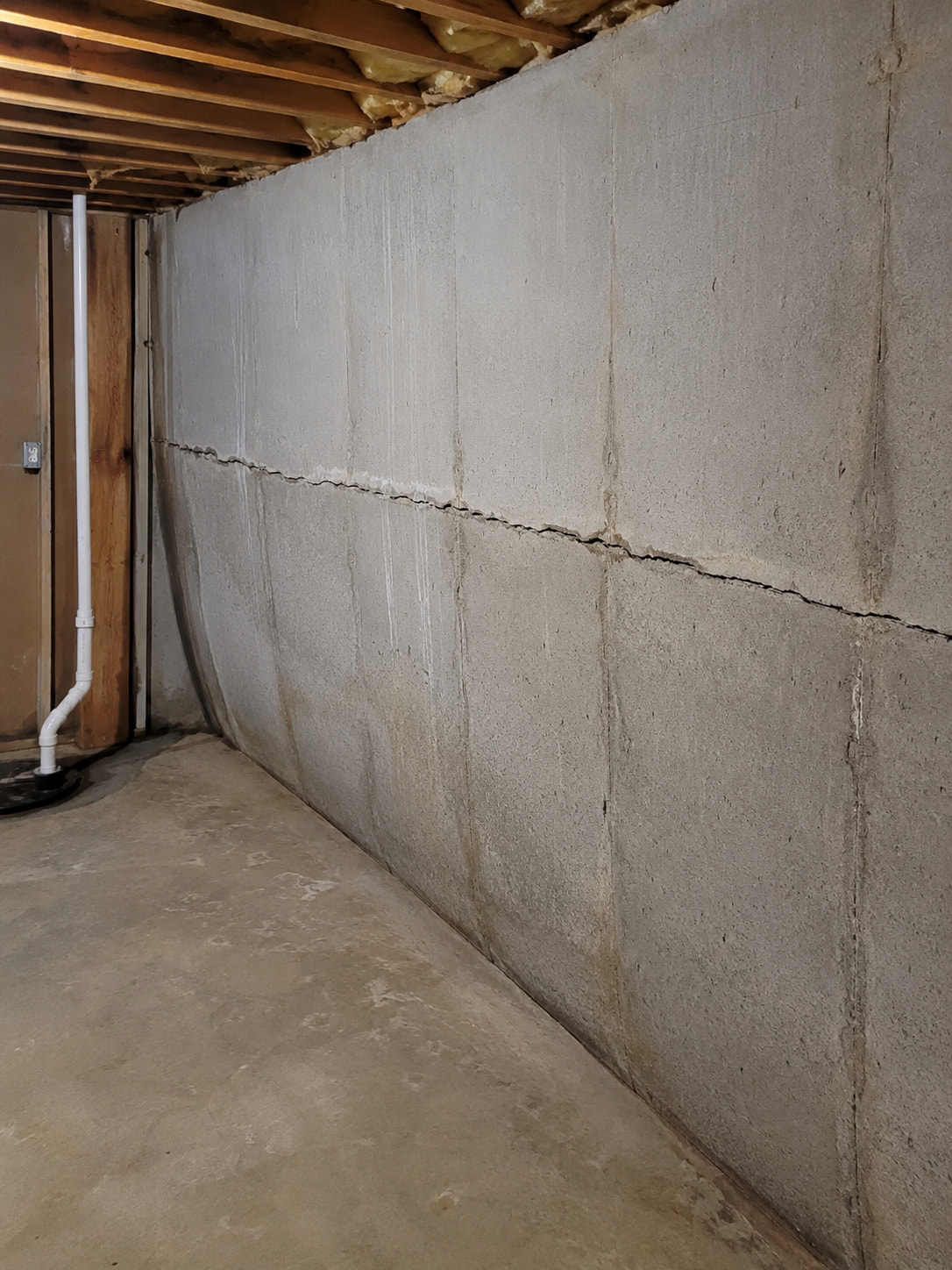 Bowing and cracked basement wall showing structural pressure and movement in a Southeast Michigan home